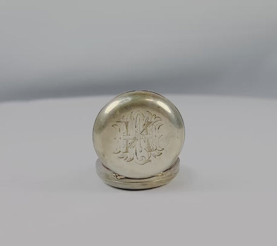 Victorian-era sterling silver sovereign holder with engraved monogram and spring-loaded mechanism, circa 1880s, United Kingdom. Compact and elegantly crafted for securely holding sovereign coins. Reflects 19th-century silverwork craftsmanship, utility, and personalized luxury accessories.