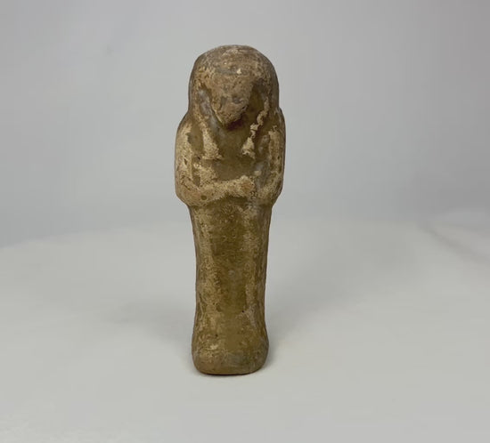 360-degree video of an ancient Egyptian sandstone ushabti rotating on a white background