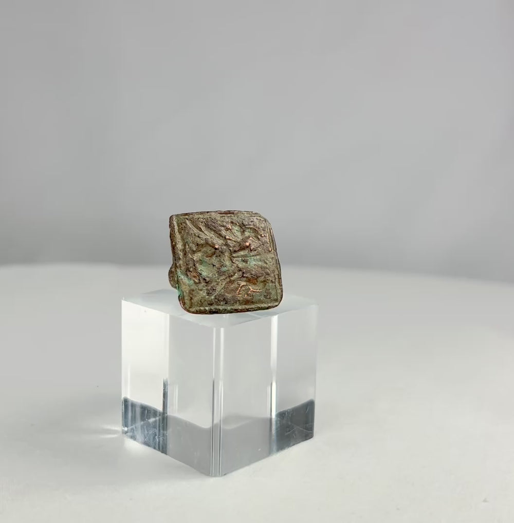 360-degree video of an ancient Mediterranean bronze ring with square bezel engraved with twin birds, showing patina, wear, and symbolic detailing
