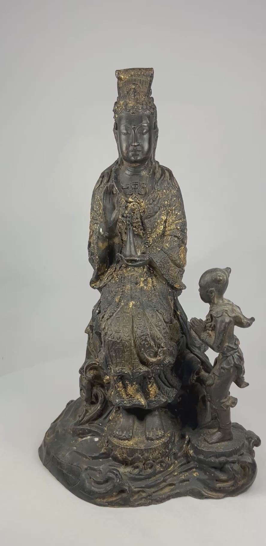 360-degree video of a late 19th–early 20th century Thai bronze Guanyin statue with child attendant, showing full lotus pedestal and remaining gilt highlights.