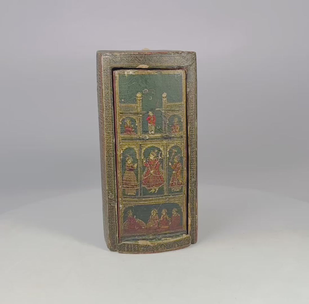 Complete 19th-century Indian Ganjifa set with 98 hand-painted round lacquered cards in paper-covered wood box decorated with polychrome palace, procession, and hunting scenes, cinnabar-red interior, reflecting South Asian miniature painting tradition.