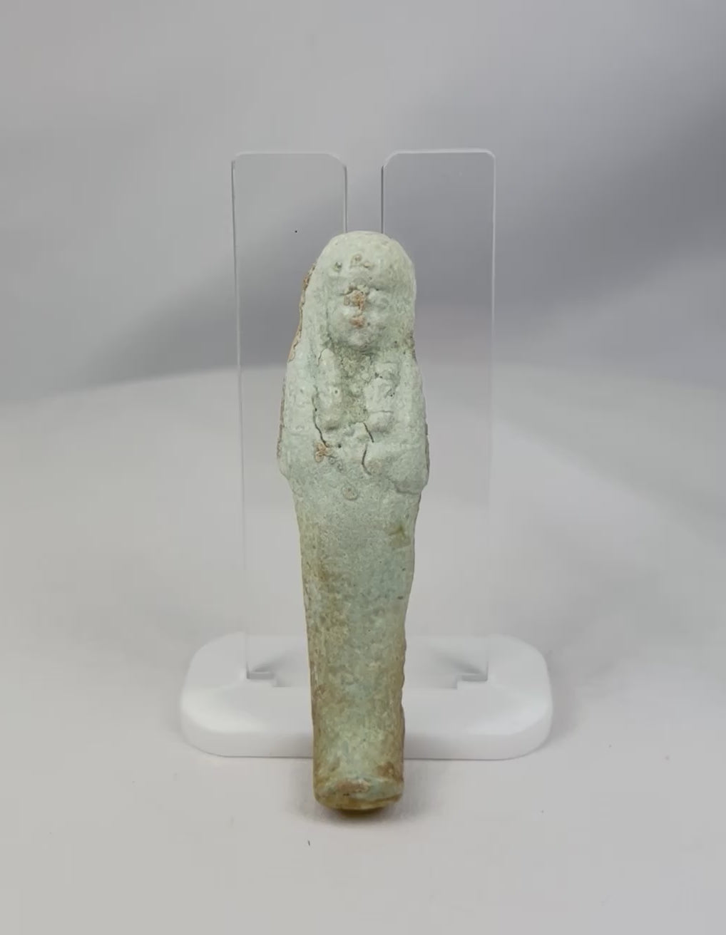 Rotating showcase video of Ancient Egyptian faience Ushabti figure featuring pale blue-green glaze, crossed-arm funerary posture, and burial patina, Late Period to early Ptolemaic, circa 664–300 BCE.