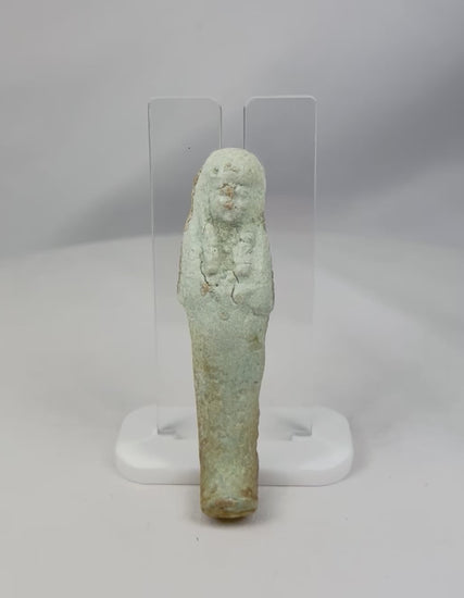 Rotating showcase video of Ancient Egyptian faience Ushabti figure featuring pale blue-green glaze, crossed-arm funerary posture, and burial patina, Late Period to early Ptolemaic, circa 664–300 BCE.