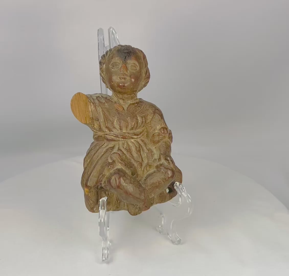 18th–19th century Spanish Colonial wooden figurine of the Christ Child or child saint. Hand-carved folk art style with expressive face, draped clothing, traces of original polychrome, and natural patina. Devotional object reflecting Colonial Latin American religious traditions and daily spiritual practice.