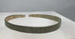 Rotating view of an ancient Western Asiatic penannular bronze bracelet with a flat-section band, stylized animal-head terminals, incised hatched decoration, pointillé triangles, annulet motifs, tapered ends, and green, blue-green, brown, and earthen archaeological patination