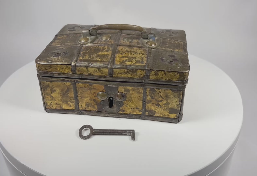 360-degree view of an early 19th century Eastern European iron-bound jewelry casket with gilt frost patterned metal panels, riveted iron straps, and original working key.