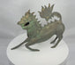 360-degree view of an antique Chinese bronze qilin sculpture with a horned head, open mouth, dorsal spines, arched tail, and naturally aged green patina.