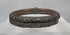 Rotating view of an antique Qing Dynasty Chinese bracelet constructed from parallel bamboo sections with applied silver-alloy floral decoration, metal collars, original bindings, and an aged patina