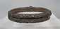 Rotating view of an antique Qing Dynasty Chinese bracelet constructed from parallel bamboo sections with applied silver-alloy floral decoration, metal collars, original bindings, and an aged patina