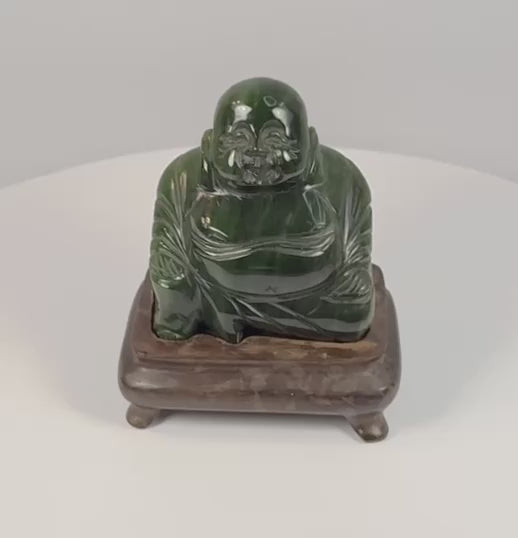 Vintage Chinese dark green hardstone Budai Laughing Buddha sculpture rotating on fitted hardwood display stand
