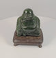 Vintage Chinese dark green hardstone Budai Laughing Buddha sculpture rotating on fitted hardwood display stand