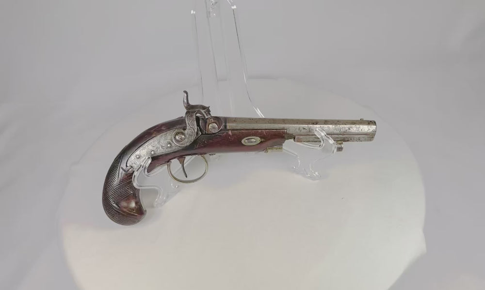 Antique Fenton London percussion pistol circa 1780–1830 displayed on clear stand, showcasing ornate steel barrel, engraved lock, and walnut stock with checkered grip.