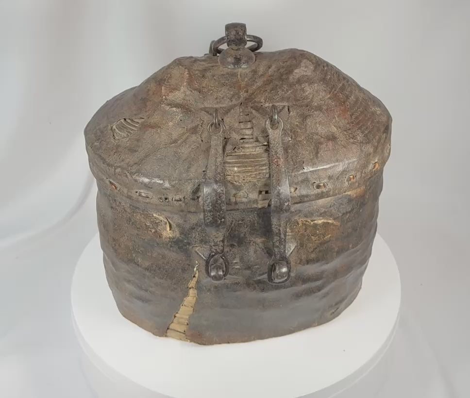 360-degree view of an antique Himalayan woven storage container featuring coiled reed basketry, leather covering, forged iron clasps, suspension ring, and authentic age-related patina.