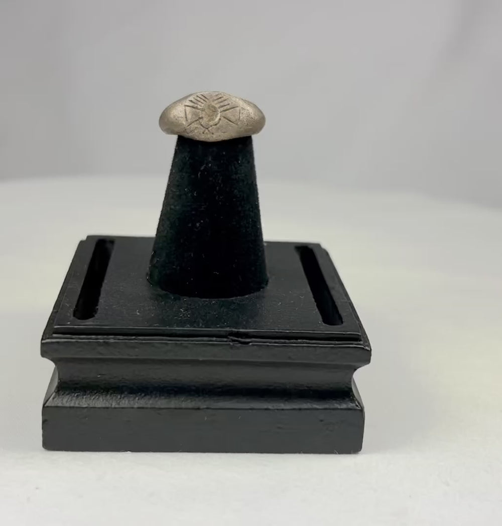 Ancient silver signet ring with finely engraved sunburst motif on bezel, thin rounded band, and natural aged patina, dating to the Late Roman to Early Byzantine period, circa 200–500 CE.