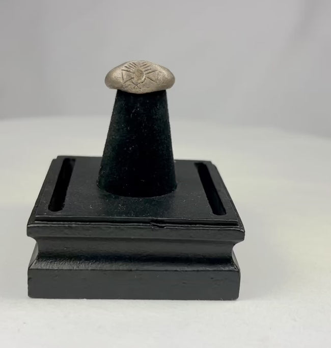 Ancient silver signet ring with finely engraved sunburst motif on bezel, thin rounded band, and natural aged patina, dating to the Late Roman to Early Byzantine period, circa 200–500 CE.
