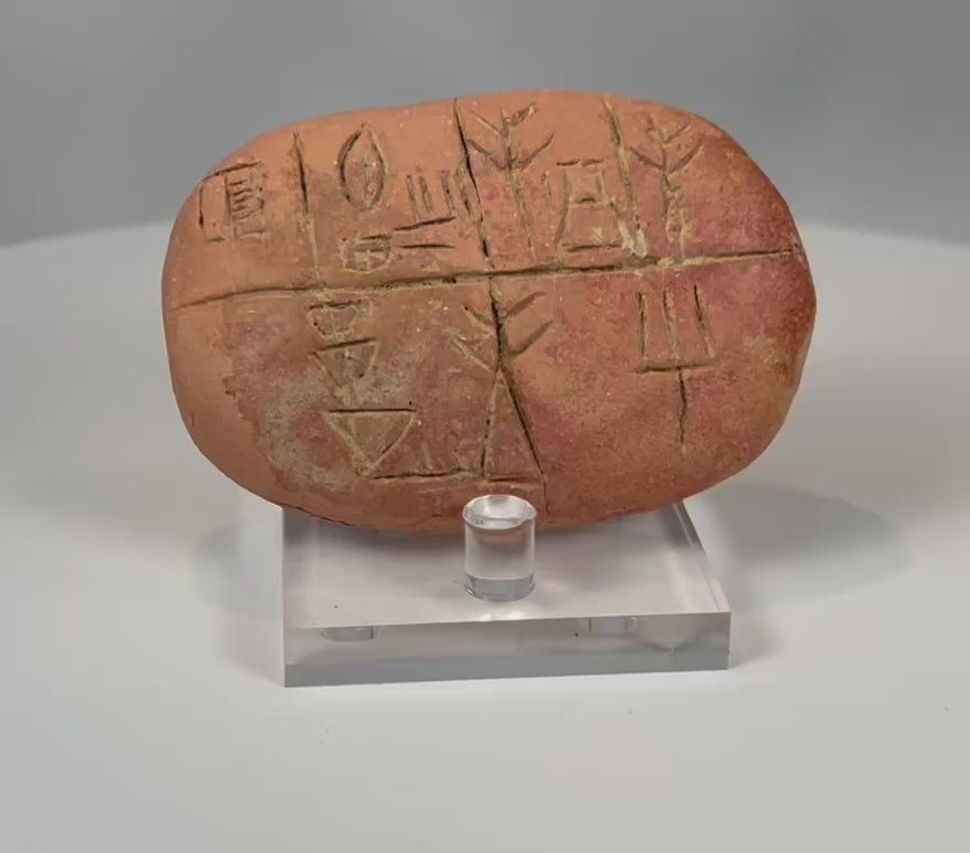 Video showcasing ancient Mesopotamian clay tablet with cuneiform script detailed inscriptions and aged patina from multiple angles