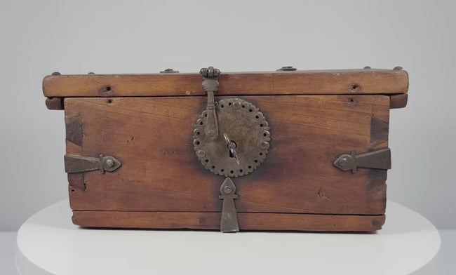 Antique Himalayan elmwood and hand-forged iron lockbox, circa 1780–1820, featuring a decorative circular hasp plate, reinforced iron fittings, original working lock and ornate key.