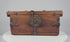 Antique Himalayan elmwood and hand-forged iron lockbox, circa 1780–1820, featuring a decorative circular hasp plate, reinforced iron fittings, original working lock and ornate key.