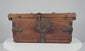 Antique Himalayan elmwood and hand-forged iron lockbox, circa 1780–1820, featuring a decorative circular hasp plate, reinforced iron fittings, original working lock and ornate key.