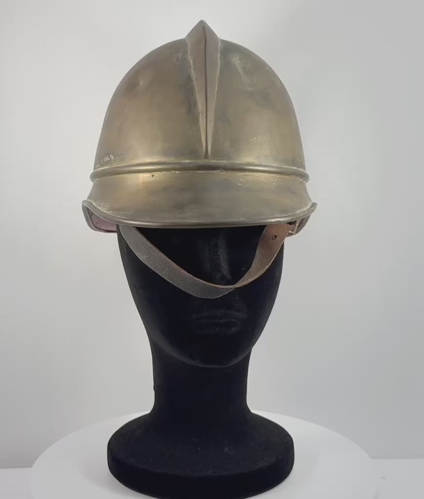 Rotating video of antique Bavarian German brass firefighter helmet with leather liner and chinstrap, circa 1908–1934