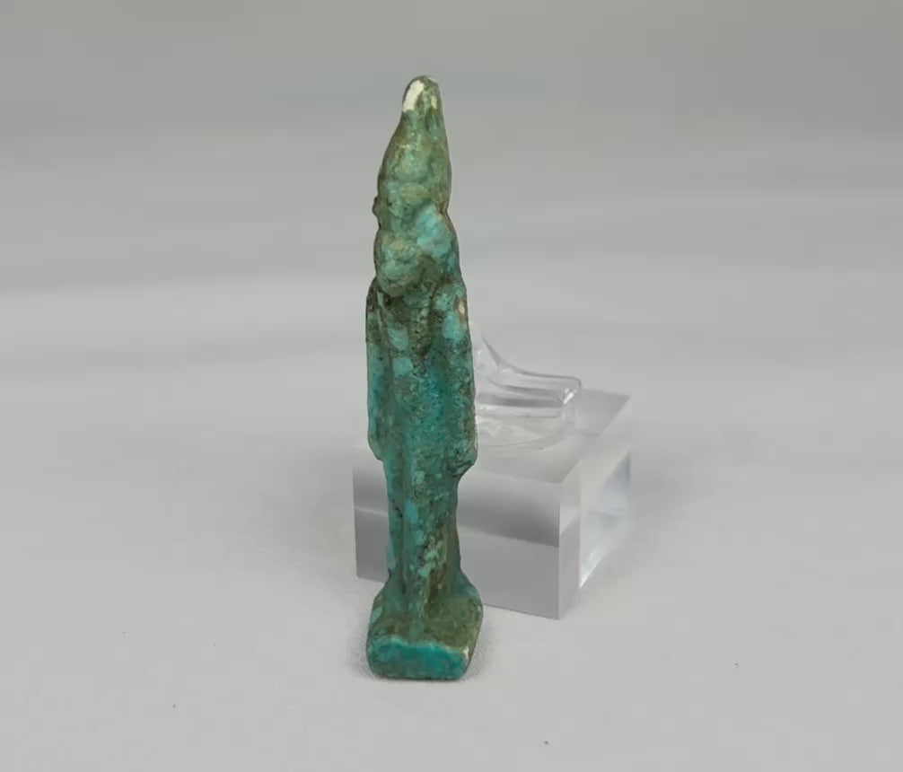 Ancient Egyptian turquoise faience amulet depicting Sekhmet, the lioness-headed warrior goddess, Late Period (664–332 BCE). Compact protective charm with finely modeled feline head, plain wig, and vibrant turquoise-to-green-blue glaze. Worn for divine protection, strength, and healing, reflecting Egyptian devotional artistry.