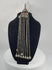 Antique Afghan Kuchi tribal pendant featuring a cylindrical hirz prayer tube, red glass cabochons, silver-toned metalwork, cascading chain tassels, and bell-shaped pendants, showcasing traditional nomadic ceremonial craftsmanship from the late 19th to early 20th century.