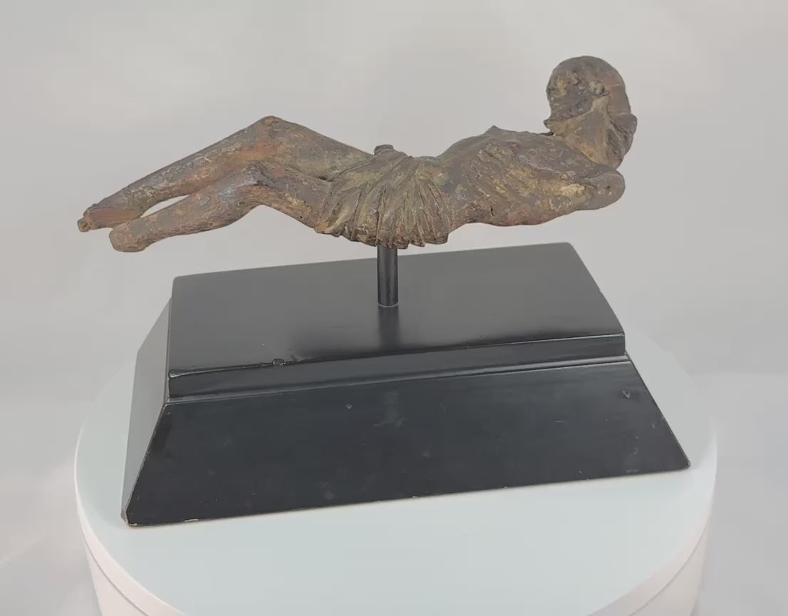 Video showing a 17th-century European Baroque carved wooden crucifix depicting Christ with bowed head, detailed hair and beard, emaciated limbs, carved loincloth, and a naturally aged patina from centuries of devotional use.