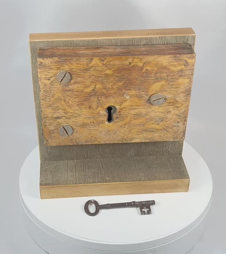 360-degree rotating view of antique mortise lock with skeleton key showing wood grain, iron hardware, and overall structure