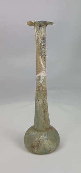 360° view of an ancient Roman glass unguentarium showing slender neck, rounded base, and beautiful archaeological patina