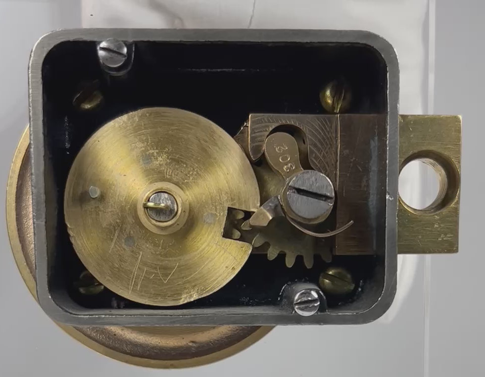 Antique safe lock mechanism back view demonstrating working gears and internal cam system in motion