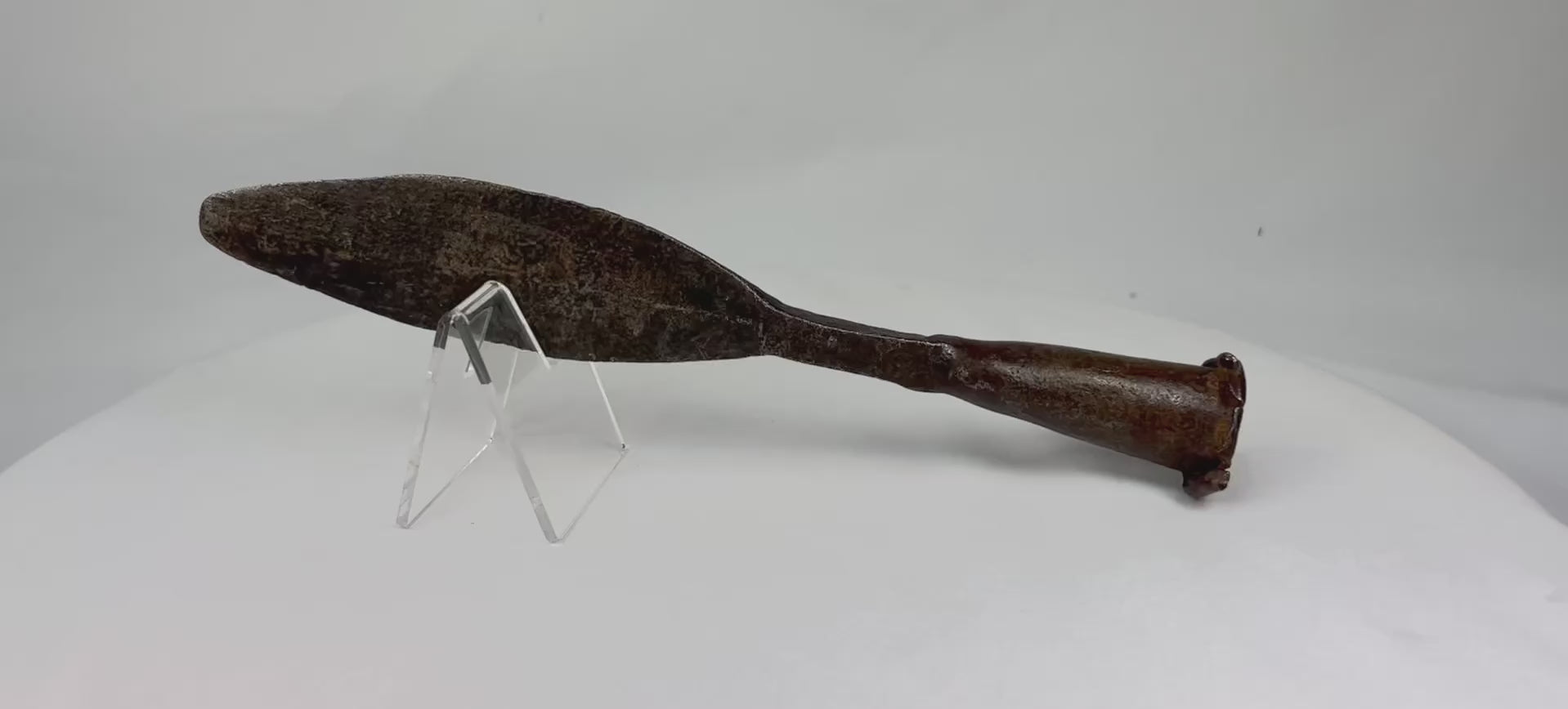 Antique European iron socketed spearhead, 18th century or earlier, featuring a double-edged leaf-shaped blade and rolled socket base. The piece shows natural patina and age-related wear, reflecting historic craftsmanship and its use in hunting, warfare, and ceremonial contexts.