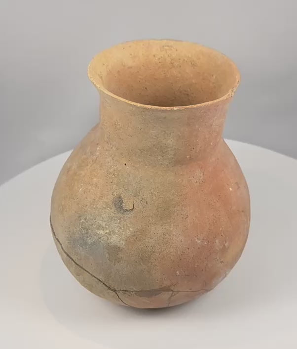 Rotating presentation of an ancient Pre-Columbian Central American earthenware vessel with a globular body, tall neck, flared rim, and visible restoration