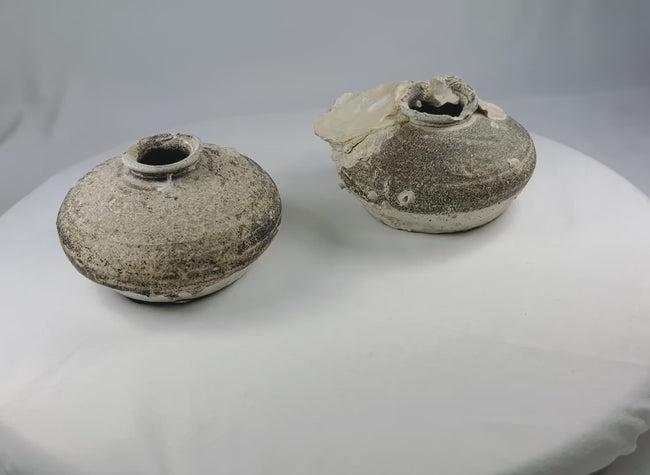 360-degree view of pair of Ming Dynasty Sawankhalok shipwreck jarlets showing marine encrustations, partial brown glaze, and authentic maritime patina.