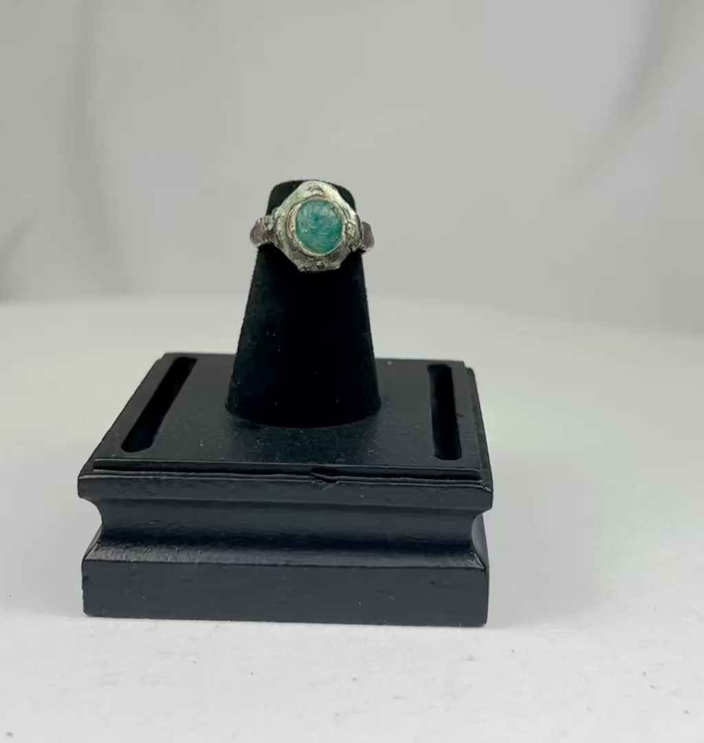 Ancient silver ring from the Near East or Mediterranean, 1st millennium BCE, featuring an engraved prancing horse with mounted rider and a raised turquoise bezel. Silver band with natural patina highlights fine ancient metalworking, symbolizing nobility, strength, and protective talismanic power.