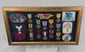 Rotating view of a framed U.S. Navy veteran shadow box featuring USS Norris DD-859 insignia, medals, ribbon bars, embroidered patches, and portrait photograph within a wooden display case.