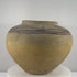 Antique Huastec terracotta water jar from Hidalgo, Mexico, dating to circa 1900–1920, featuring a traditional rounded olla form, gently flared neck, wide opening, hand-painted floral and flowing geometric motifs in dark mineral pigment, natural earthen patina, and traditional Mexican pottery craftsmanship.