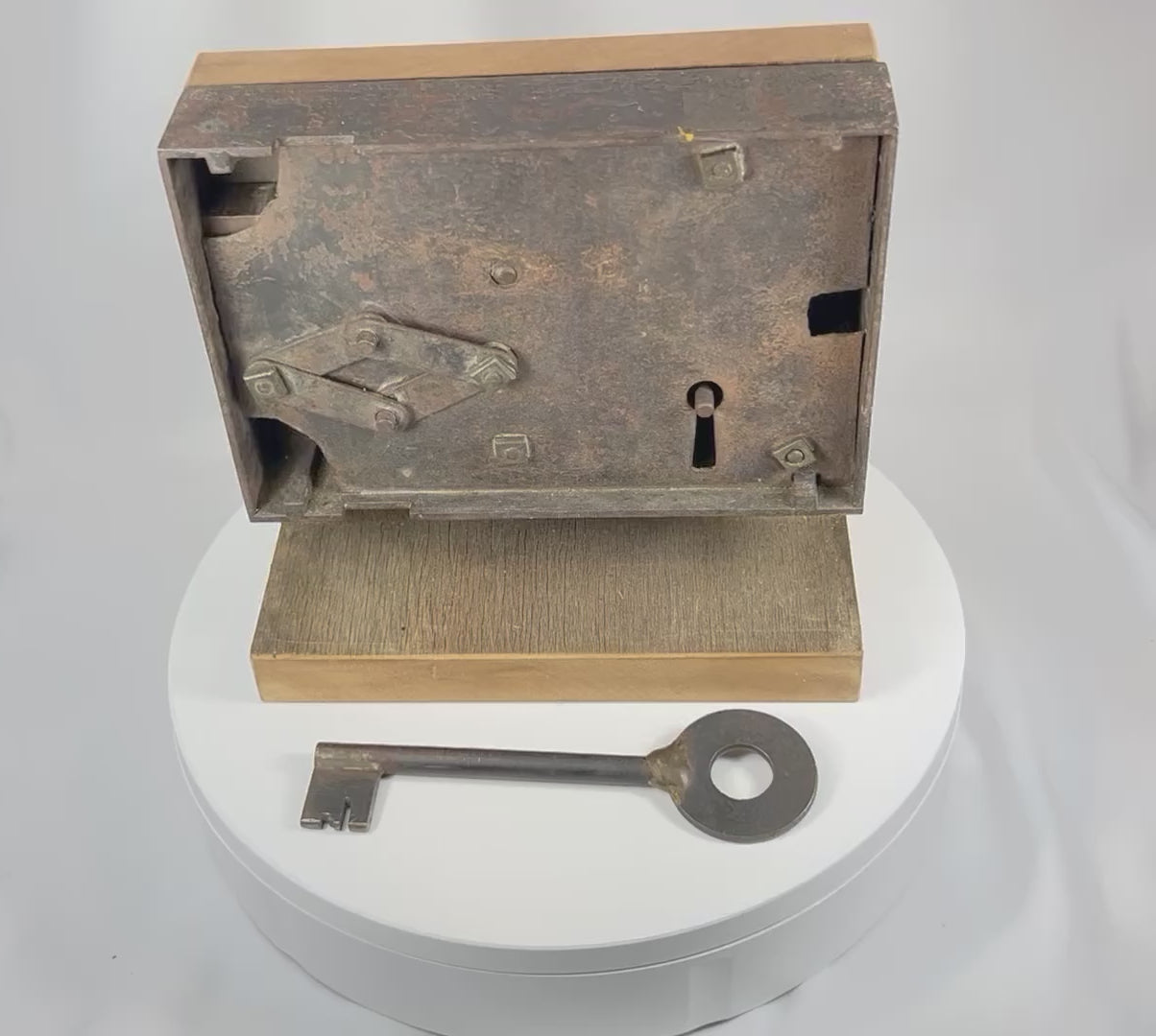 Video demonstrating antique rim lock mechanism with skeleton key being inserted and turned to show internal locking function