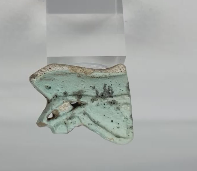 Rotating video of an ancient Egyptian blue-green faience Eye of Horus amulet fragment.