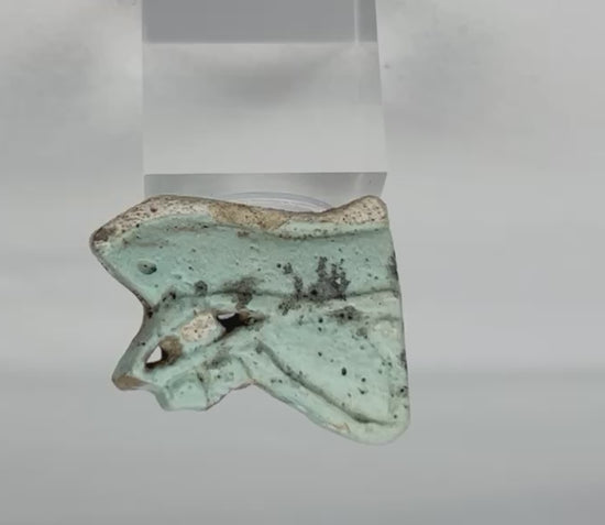 Rotating video of an ancient Egyptian blue-green faience Eye of Horus amulet fragment.