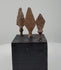 360-degree view of three antique hand-forged iron projectile points from the Roman to Medieval period, showing their distinct blade shapes, surviving tangs, and archaeological patina.