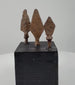 360-degree view of three antique hand-forged iron projectile points from the Roman to Medieval period, showing their distinct blade shapes, surviving tangs, and archaeological patina.