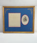 Video showcasing a framed historical presentation featuring a reproduction of an 1875 letter attributed to Civil War General William Tecumseh Sherman alongside an engraved portrait in military uniform. The display features royal-blue matting, decorative gold floral accents, red and white borders, and an ornate gilt-finished frame.