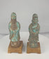 Rotating view of a pair of antique Chinese glazed pottery attendants with tall ceremonial caps, flowing robes, ritual objects, turquoise-blue and aubergine-brown glazes, and later wooden display bases