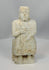 Rotating view of ancient Mesopotamian carved stone worshipper figurine with clasped hands and aged patina