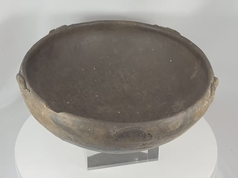 360-degree view of an ancient Pre-Columbian terracotta bowl featuring raised rim lugs, a dark fire-clouded surface, burnished finish, and authentic archaeological patina.