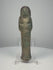 Ancient Egyptian blue-green glazed faience ushabti from the Third Intermediate Period, 21st–22nd Dynasties, circa 1070–715 BCE, featuring crossed arms, a tripartite wig, surviving black-painted hieroglyphic inscriptions, and aged turquoise glaze. Formerly in the Dr. Bruce L. Ralston Collection.