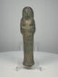 Ancient Egyptian blue-green glazed faience ushabti from the Third Intermediate Period, 21st–22nd Dynasties, circa 1070–715 BCE, featuring crossed arms, a tripartite wig, surviving black-painted hieroglyphic inscriptions, and aged turquoise glaze. Formerly in the Dr. Bruce L. Ralston Collection.