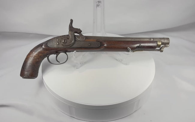 Rotating view of a mid-19th-century Afghan percussion holster pistol with a hardwood stock, engraved iron lock, brass muzzle mount, and original captive ramrod