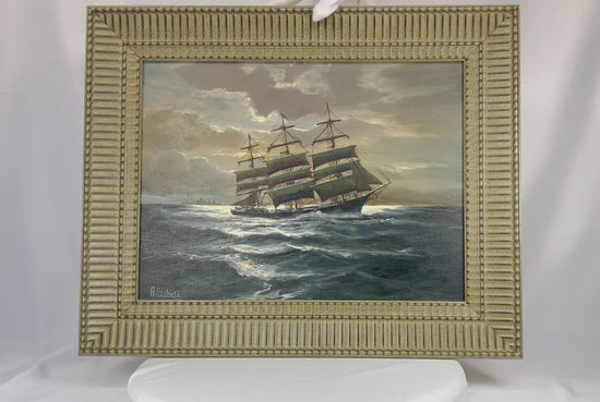 Signed oil on canvas board painting titled “Ships That Pass In The Night” by Alfred Gabali (1886–1963), circa 1958. Maritime scene depicting ships at sea with expressive brushwork and refined ocean and sky tones. Dedicated on verso to Carol Anne Kahne. Reflects Gabali’s German heritage, seafaring background, and Cape Cod art community influence.
