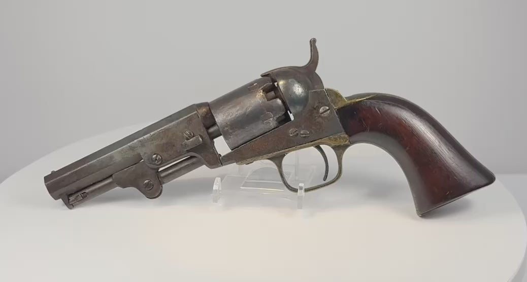 Video of an 1859 Colt Model 1849 Pocket Revolver with an octagonal barrel, aged brass fittings, and a curved walnut grip.